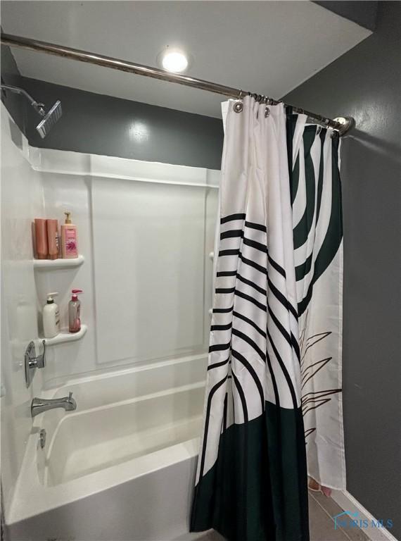 bathroom featuring shower / bath combo with shower curtain