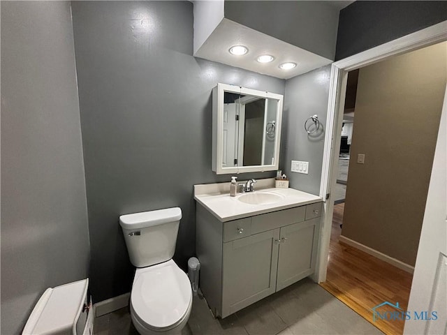 bathroom featuring toilet, tile patterned floors, and vanity