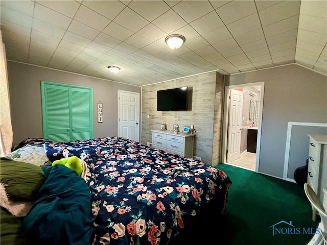 carpeted bedroom featuring ensuite bath