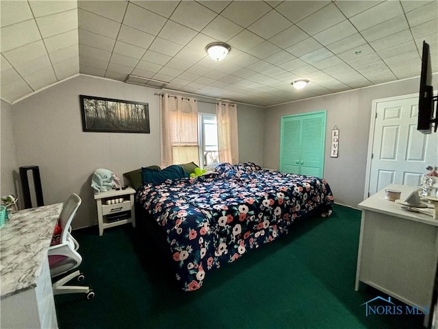 bedroom with vaulted ceiling and dark carpet