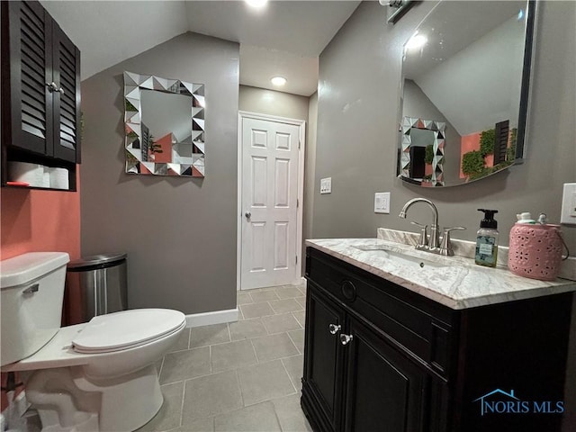 bathroom featuring toilet, vanity, and tile patterned flooring