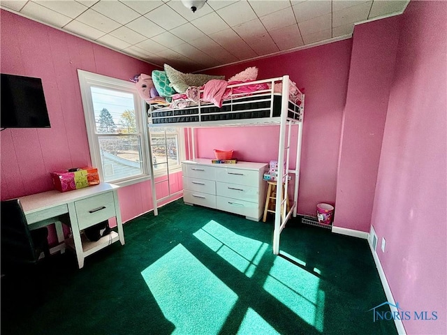 bedroom featuring dark carpet