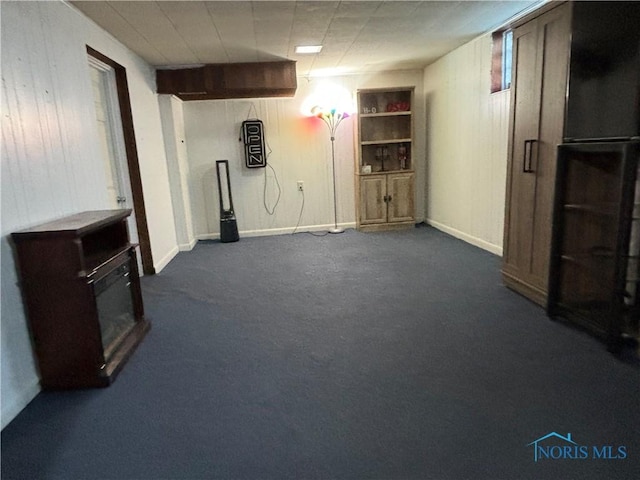 basement with dark carpet