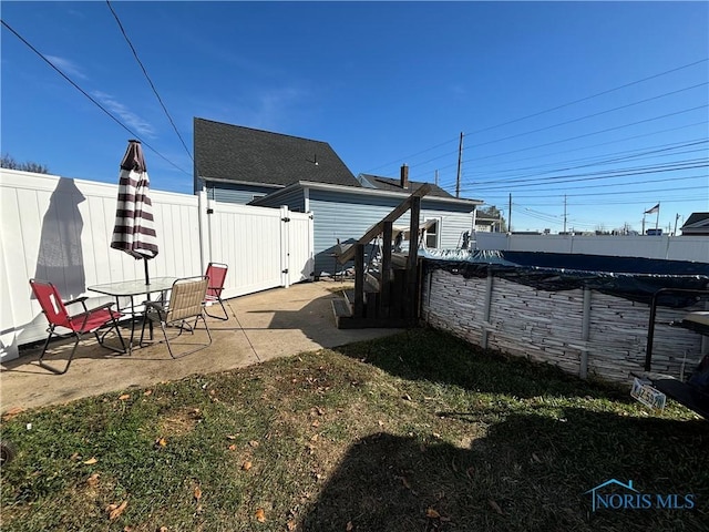 view of yard with a patio area and a covered pool