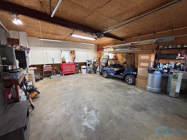 garage featuring a garage door opener and a workshop area