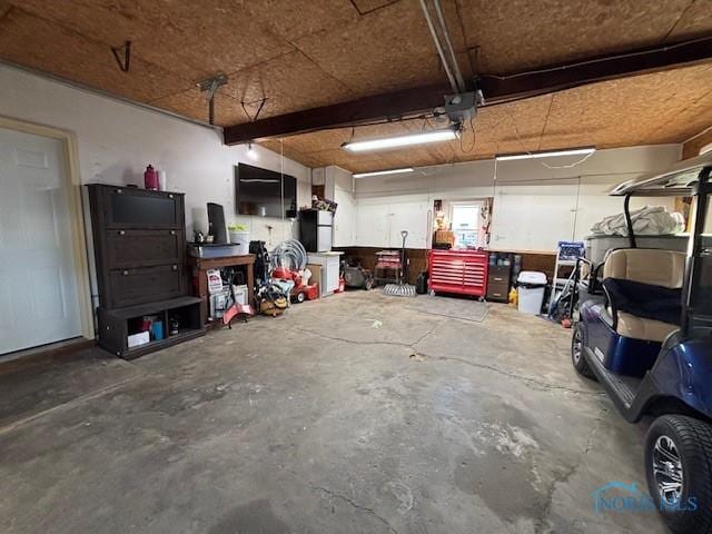 garage with a garage door opener and a workshop area