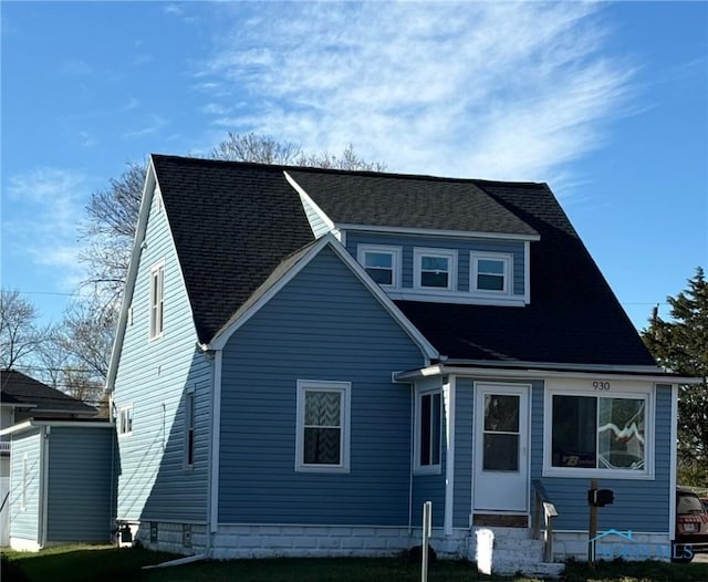 rear view of property featuring a yard