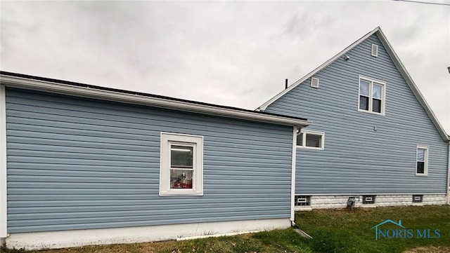 view of home's exterior with a yard