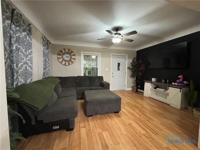 living room with ceiling fan and light hardwood / wood-style flooring