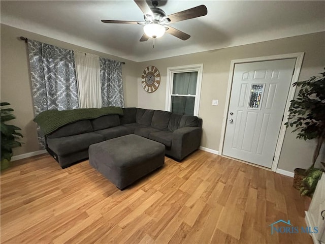 living room with ceiling fan and light hardwood / wood-style flooring