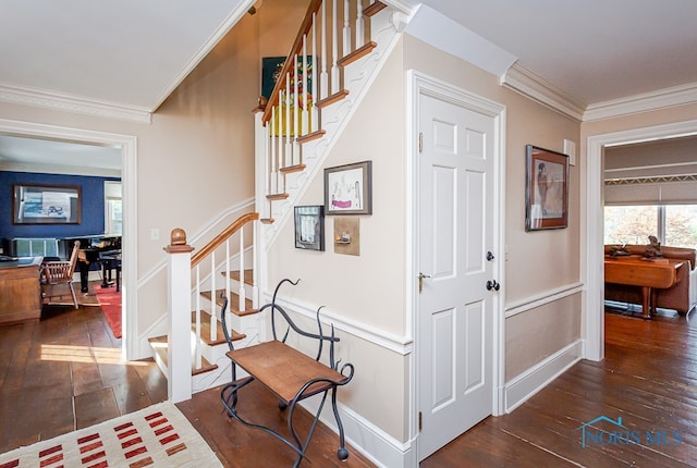 stairway with crown molding and hardwood / wood-style floors