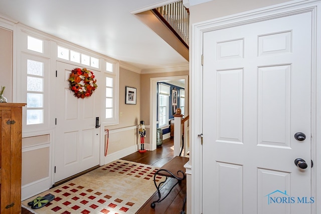 foyer with ornamental molding, dark hardwood / wood-style flooring, and plenty of natural light