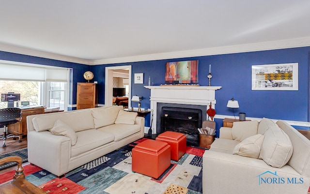 living room featuring hardwood / wood-style flooring and ornamental molding