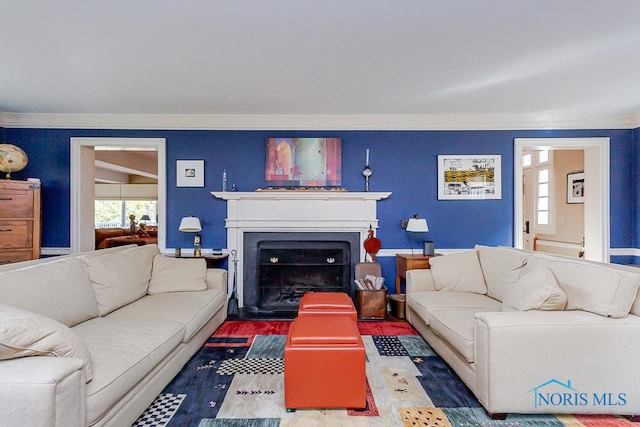 living room with vaulted ceiling, hardwood / wood-style flooring, ornamental molding, and a wealth of natural light