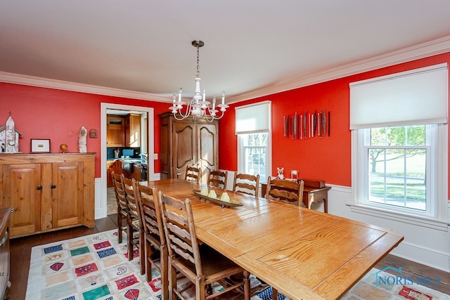 dining room with an inviting chandelier, crown molding, and hardwood / wood-style floors