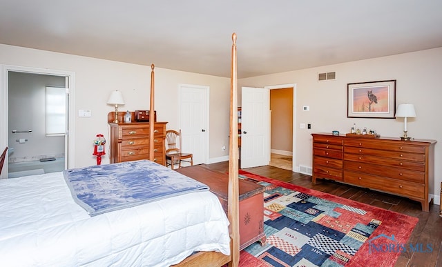 bedroom featuring dark hardwood / wood-style floors and ensuite bathroom