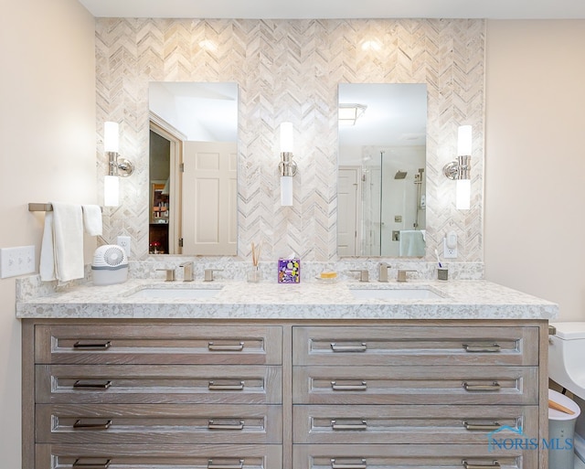 bathroom featuring vanity and backsplash