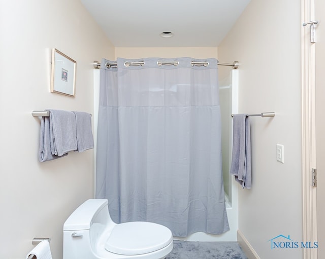 bathroom with toilet and shower / tub combo