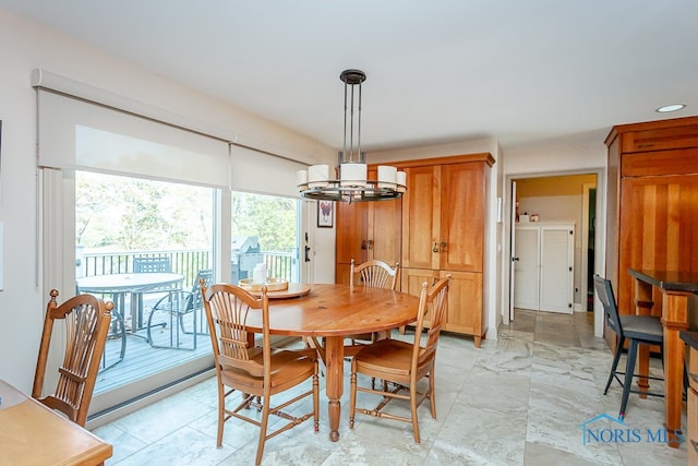 dining area with an inviting chandelier