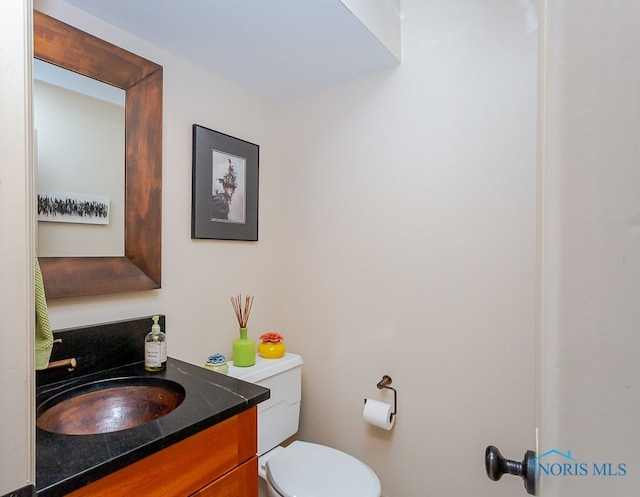 bathroom featuring vanity and toilet