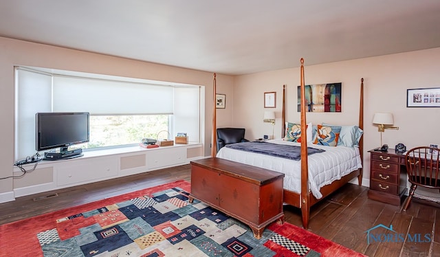 bedroom with dark wood-type flooring