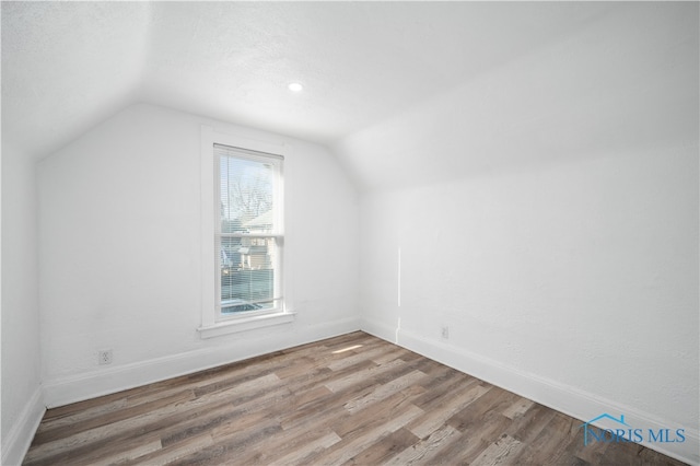 bonus room featuring hardwood / wood-style floors and vaulted ceiling