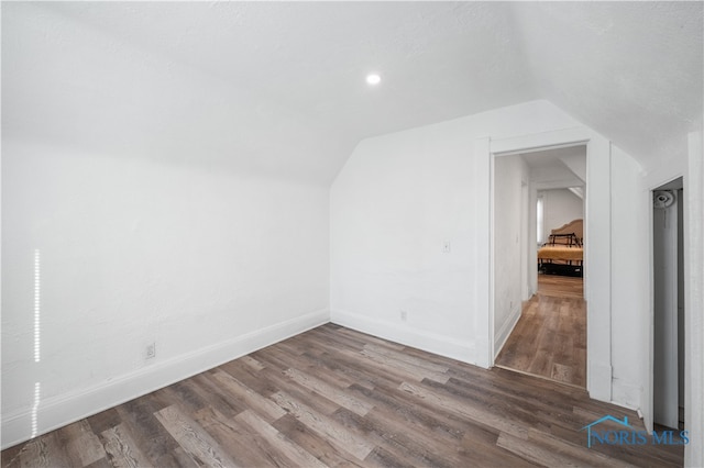 bonus room with lofted ceiling and hardwood / wood-style flooring