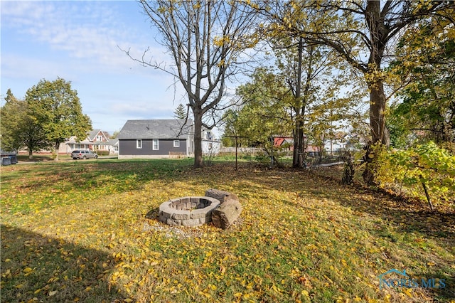 view of yard with an outdoor fire pit