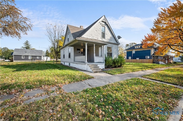 view of front of home with a porch and a front yard