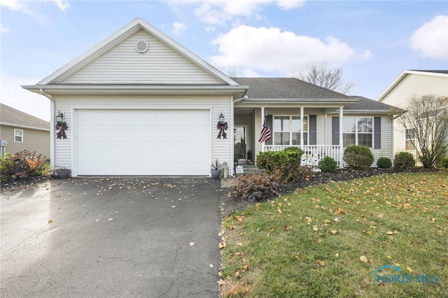 view of front of home with a front yard, a garage, and a porch