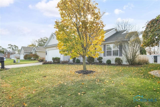 view of front of property featuring a garage and a front lawn