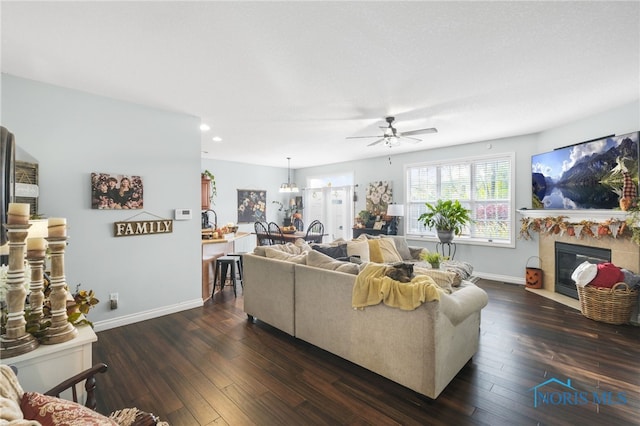 living room featuring dark hardwood / wood-style floors and ceiling fan