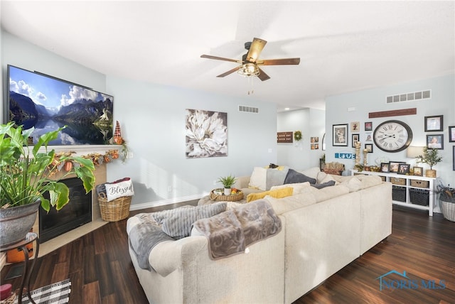 living room with dark hardwood / wood-style floors and ceiling fan