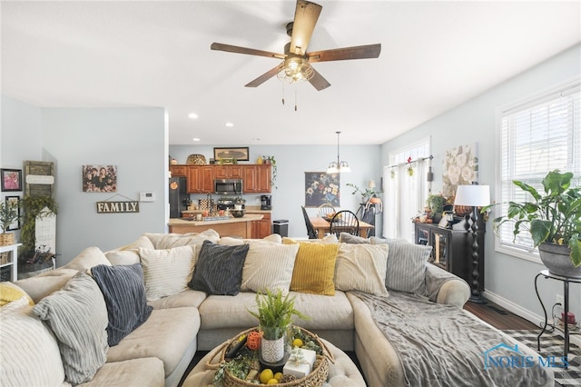 living room featuring dark hardwood / wood-style floors and ceiling fan