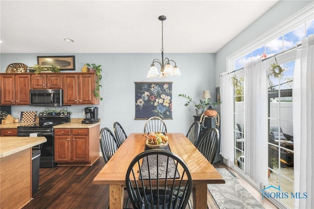 dining space featuring an inviting chandelier and dark hardwood / wood-style floors