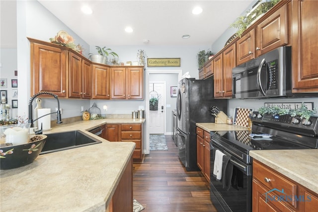 kitchen with black electric range, dark wood-type flooring, and sink