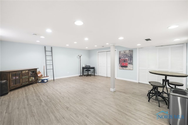 basement with light hardwood / wood-style flooring