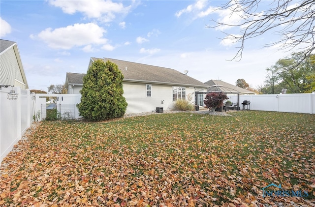 rear view of property featuring a patio and a lawn