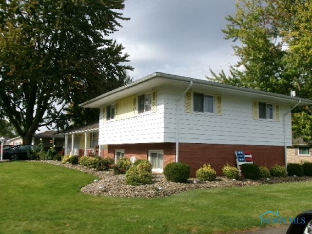 view of side of property with a yard