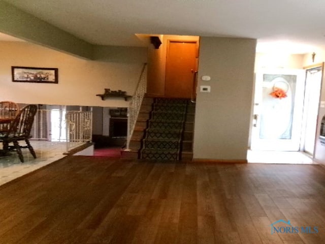 unfurnished living room with dark wood-type flooring