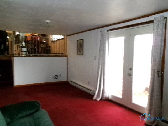 living room featuring ornamental molding, french doors, a baseboard heating unit, and carpet