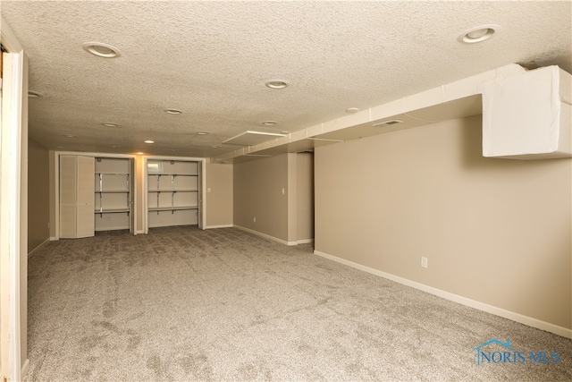 basement with a textured ceiling and carpet floors