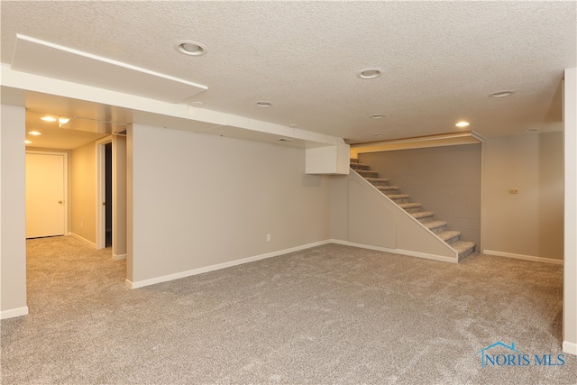 basement with light carpet and a textured ceiling