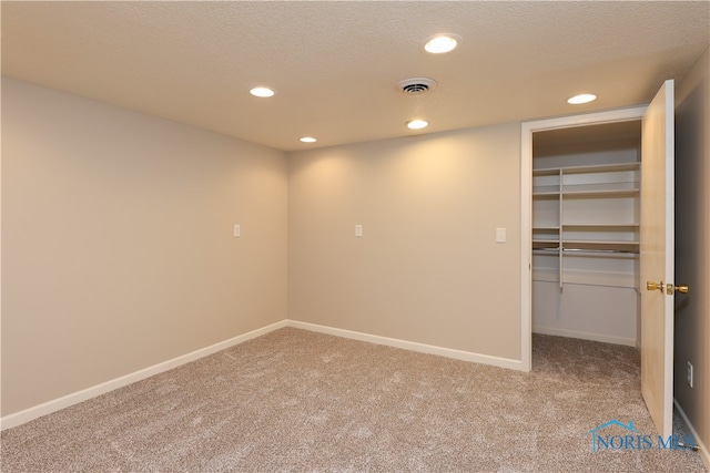 interior space with carpet and a textured ceiling