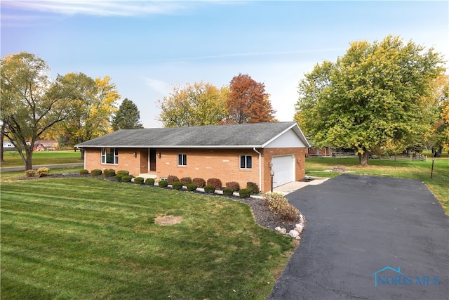 view of side of home featuring a garage and a lawn