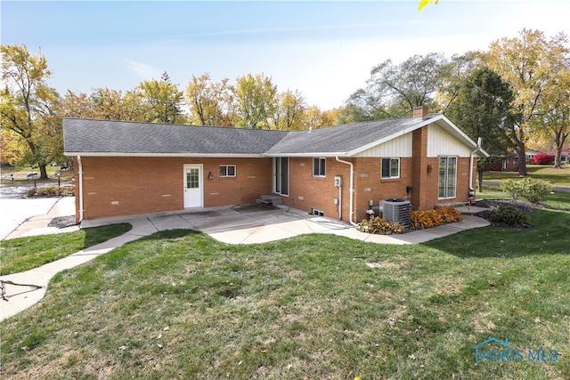 rear view of house featuring a patio area, a lawn, and central AC unit