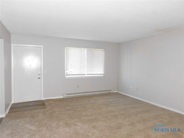 carpeted empty room with a baseboard radiator