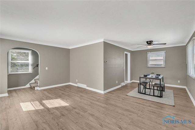 spare room with light wood-type flooring and ceiling fan