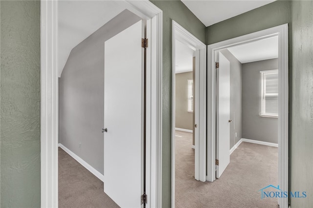 hallway featuring light carpet