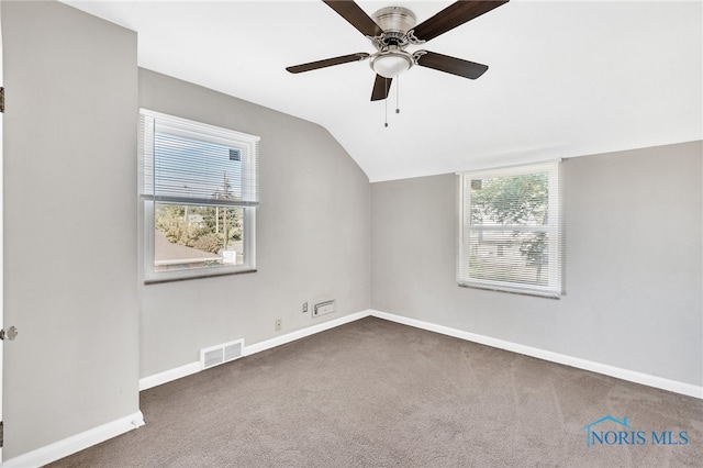 bonus room featuring dark carpet, lofted ceiling, and ceiling fan